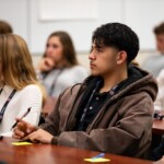Chuck Hagel speaks with high school students at the Chuck Hagel Symposium on October 17, 2023.